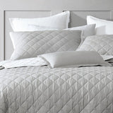 Elegant Logan & Mason Essex Bedspread in Pewter, featuring a quilted herringbone design and crisp white edges, perfect for queen beds.