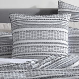 Luxurious European pillowcase featuring geo and tribal motifs, tufting textures, and black cord piping for a modern touch.