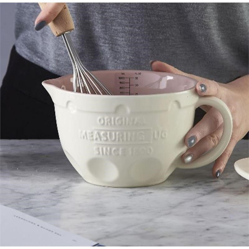 Mason Cash 1-litre measuring jug in durable stoneware with ergonomic handle, embossed logo, and internal measurement markings.