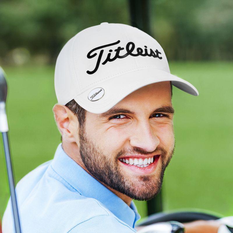White Titleist Performance Ball Marker Cap featuring moisture-wicking fabric, UV protection, and built-in ball marker magnet.