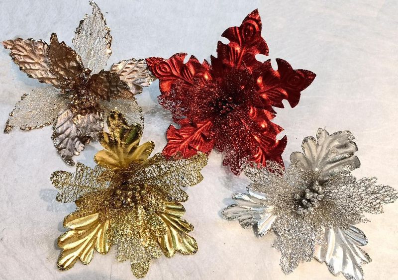 Elegant copper artificial poinsettia flower made of metal and mesh, featuring a clip for versatile decorating options.