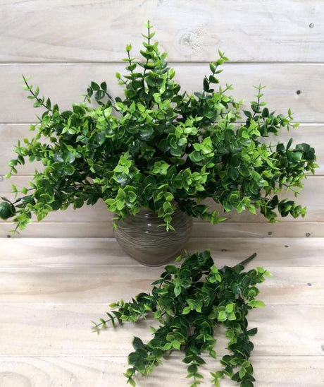 Artificial green eucalyptus bush in a decorative pot, ideal for low-maintenance home decor and floral arrangements.