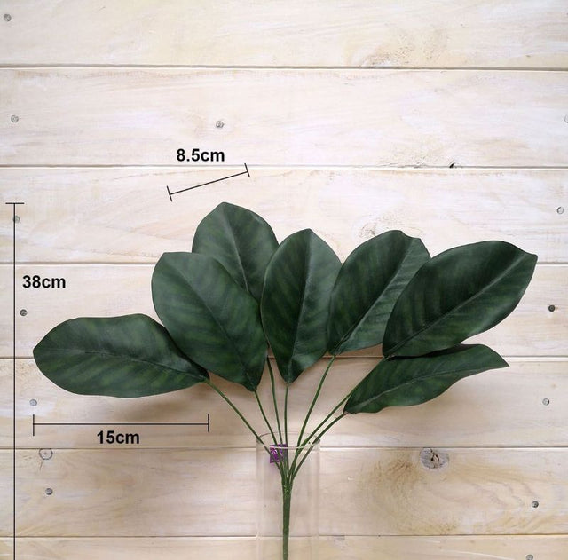Large artificial magnolia leaf bush in lush green, perfect for stylish home and event decor without maintenance.