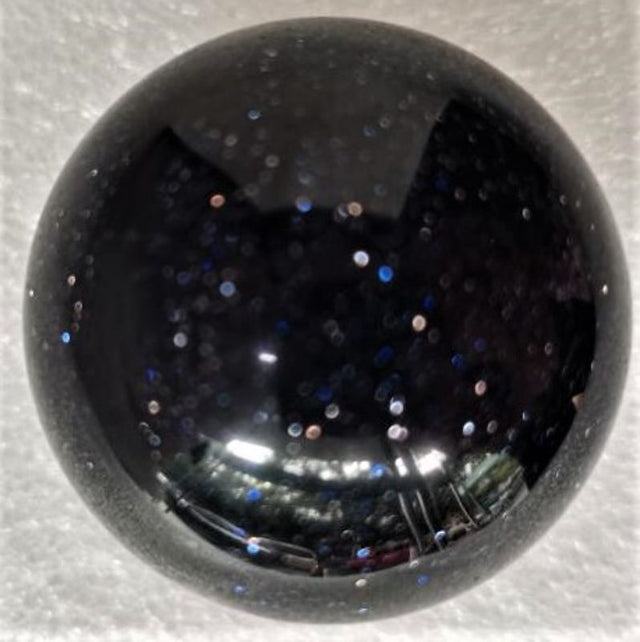 Blue goldstone sphere (4CM) showcasing a deep blue hue with sparkling flecks, ideal for decor or healing purposes.