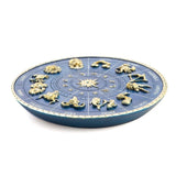 Deep blue zodiac incense burner with gold-painted symbols, perfect for creating a serene atmosphere at home.