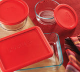 Glass storage container with secure red lid, ideal for food preservation and microwave safe, capacity 6 cups.