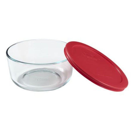 Clear glass Pyrex 4 cup round container with a secure red lid, perfect for versatile food storage and easy reheating.