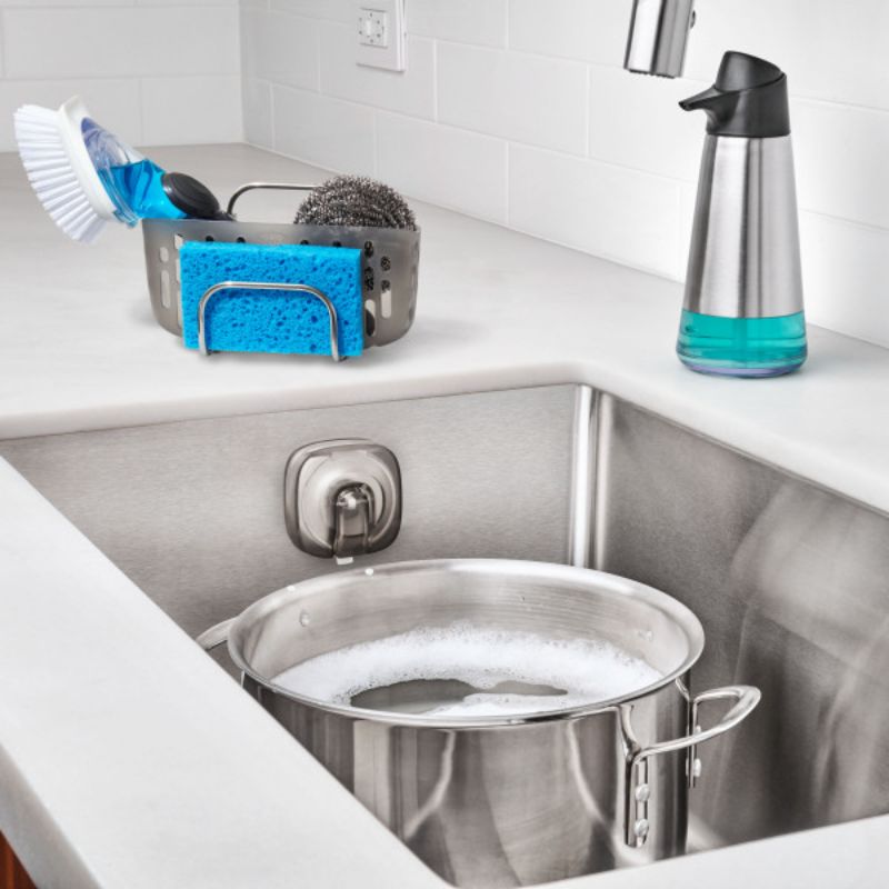 Suction sink caddy with stronghold cups, large basket for sponges and brushes, stylish hook, and dishwasher safe for easy cleaning.