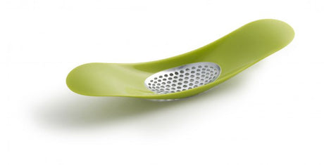 Vibrant green garlic rocker by Joseph Joseph with a curved design for easy crushing and collection of garlic cloves.