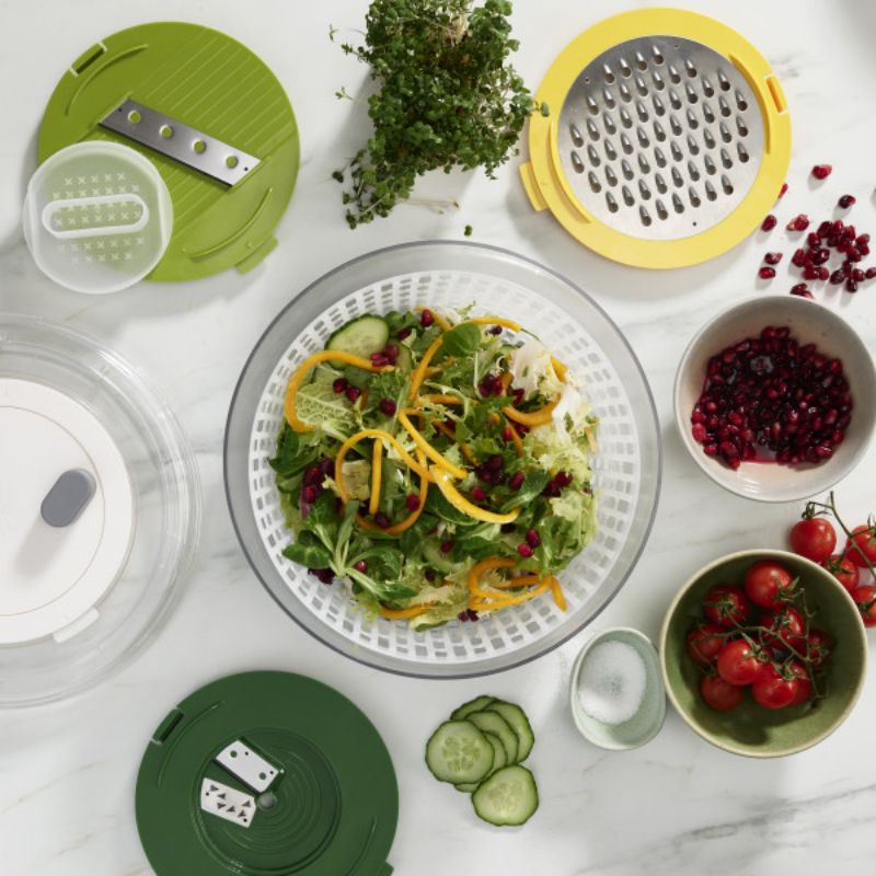 Colorful 4-piece salad prep set with spiralizer, slicer, grater, and spinner, designed for easy and safe meal preparation.