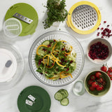 Colorful 4-piece salad prep set with spiralizer, slicer, grater, and spinner, designed for easy and safe meal preparation.