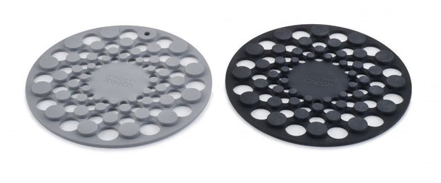 Joseph Joseph Spot-On Set of 2 Grey Silicone Trivets, round, heat-resistant, with raised dot design for stability and easy storage.