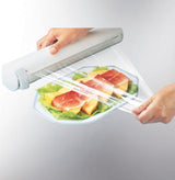 Leifheit wall-mounted kitchen roll holder for efficient organization, featuring removable containers and sharp blades for precise cuts.