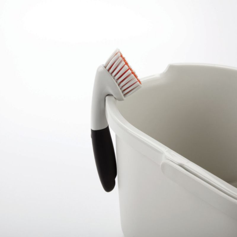 OXO Goodgrips Grout Brush with sturdy bristles and ergonomic grip for effective cleaning of grout and tight spaces.