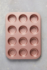 Wiltshire perforated tart & quiche pan with 12 cups in elegant rose gold for perfect pastries and easy cleanup.