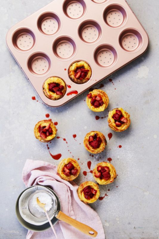 Rose gold perforated tart and quiche pan with 12 cups for even baking and easy food release, perfect for mini treats.