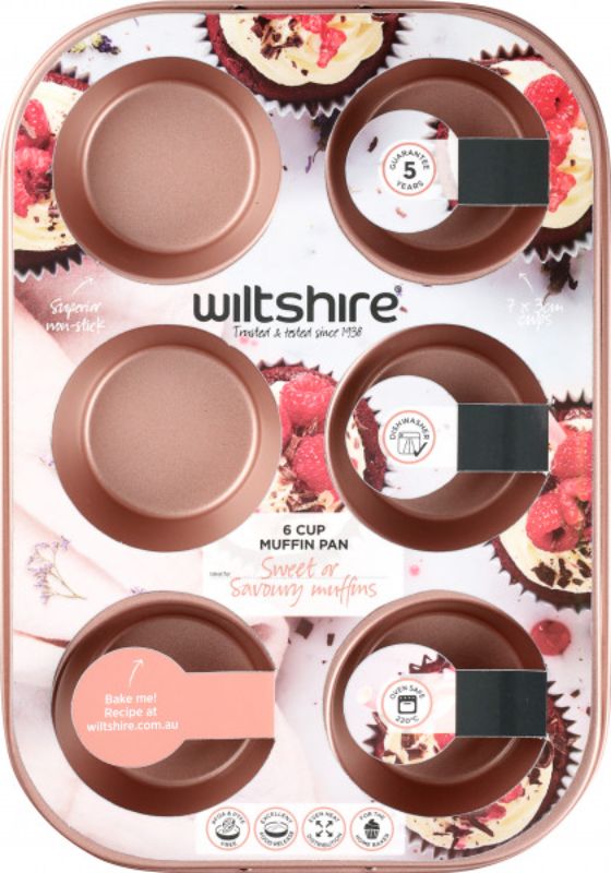 Rose gold 6-cup muffin pan by Wiltshire, featuring non-stick coating and elegant design for stylish baking.