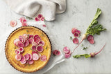 Rose gold 24cm quiche and tart pan with non-stick surface, removable base, and embossed measurements for easy baking.