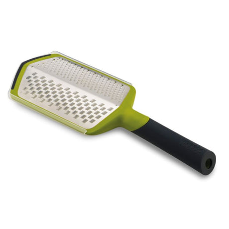 Ergonomic green grater with coarse and fine stainless-steel blades for versatile grating and easy storage collection.