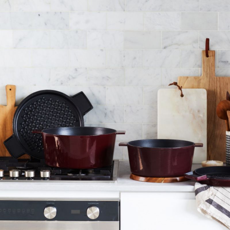 Stanley Rogers 28cm Cast Iron French Oven in Bordeaux color, featuring a dual-purpose lid, wide handles, and easy-release enamel surface.