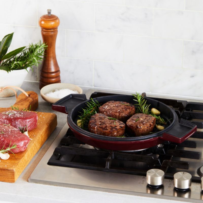 Elegant Bordeaux cast iron French oven with grill pan lid, ideal for versatile cooking and stylish kitchen presentation.