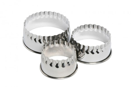 Set of three stainless steel scone and cookie cutters with crimped edges for creating uniform pastries.