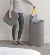 Joseph Joseph Tota 60-litre Laundry Basket in Grey with dual tote bags, easy-carry handles, and stylish design for laundry organization.