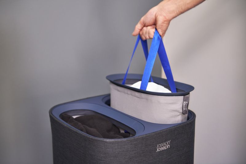 Joseph Joseph Tota 60-litre laundry basket in carbon black, featuring dual 30-litre tote bags for fabric separation.