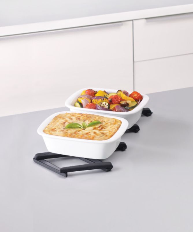 Expandable black silicone trivet from Joseph Joseph, heat-resistant up to 240°C, folds neatly for compact storage.