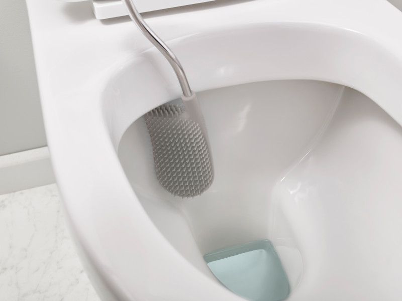 Flexible D-shaped toilet brush in grey and white, designed for thorough cleaning and minimal mess in modern bathrooms.