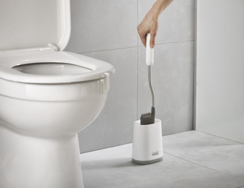 Flexible D-shaped toilet brush in grey, designed for thorough cleaning and hygienic storage with anti-drip features.