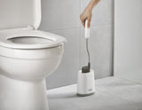 Flexible D-shaped toilet brush in grey, designed for thorough cleaning and hygienic storage with anti-drip features.