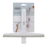 Slimline grey squeegee with a flexible blade, suction cup holder, and storage hook for bathroom organization.