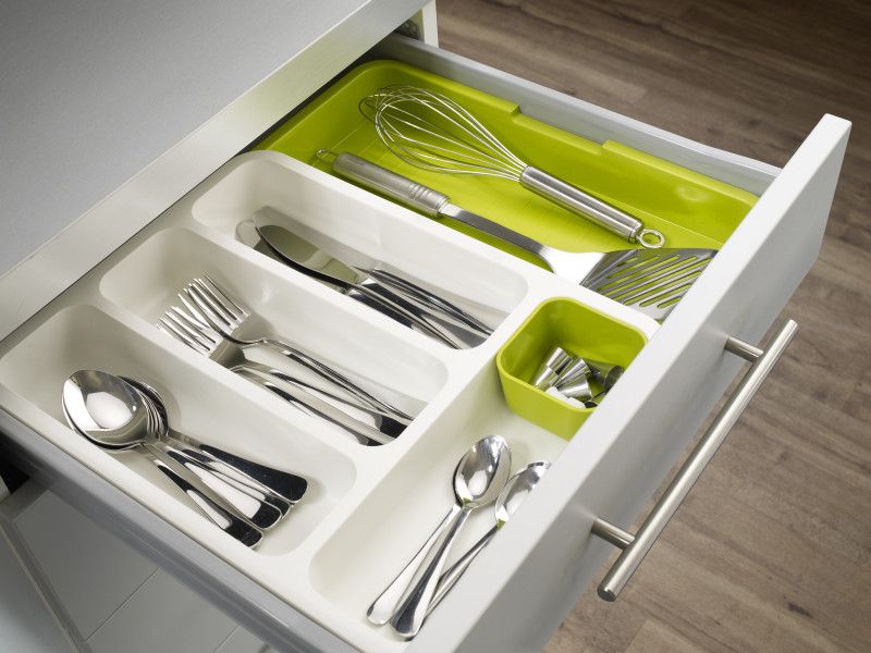 White and green Joseph Joseph cutlery tray with adjustable design and deep compartments for organized kitchen storage.