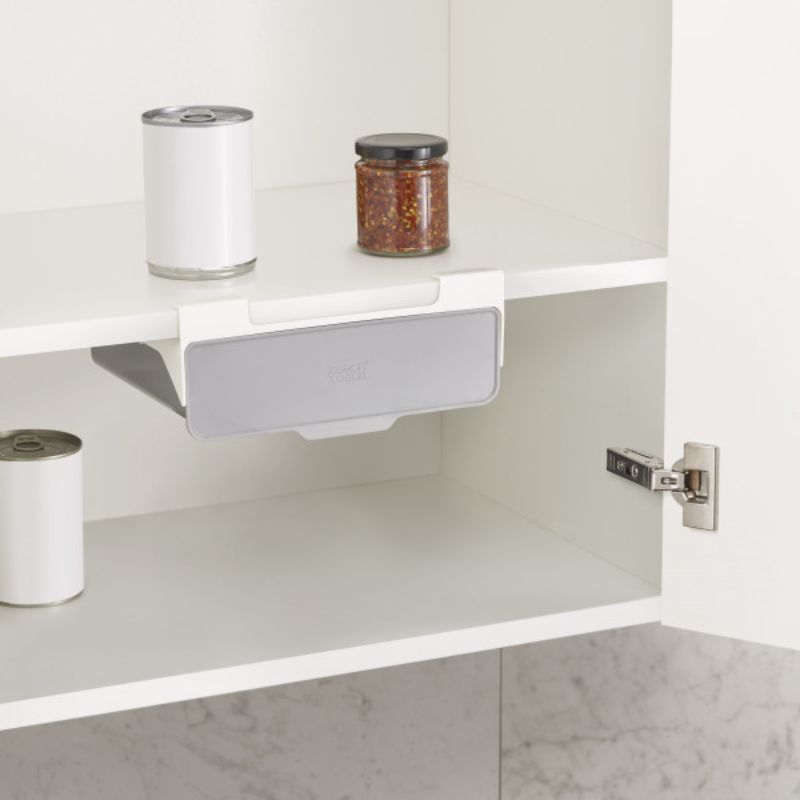 Under-shelf drawer for kitchen cabinets, optimizing space for stock cubes and packets with easy tool-free installation.