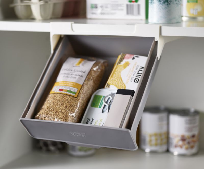 Joseph Joseph CupboardStore Under-shelf Drawer for efficient kitchen organization, utilizing shelf space for small items.