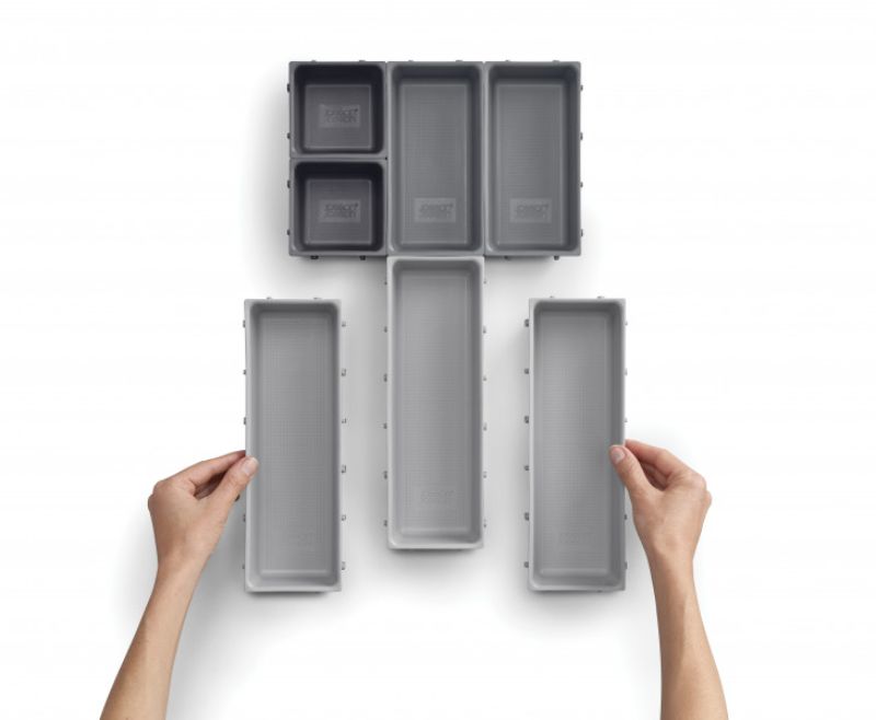 Modular 7-piece storage system with customizable trays for organized drawers in home or workspace.