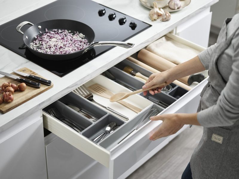 Modular 10-piece storage system with customizable trays for organized home essentials like cutlery and stationery.